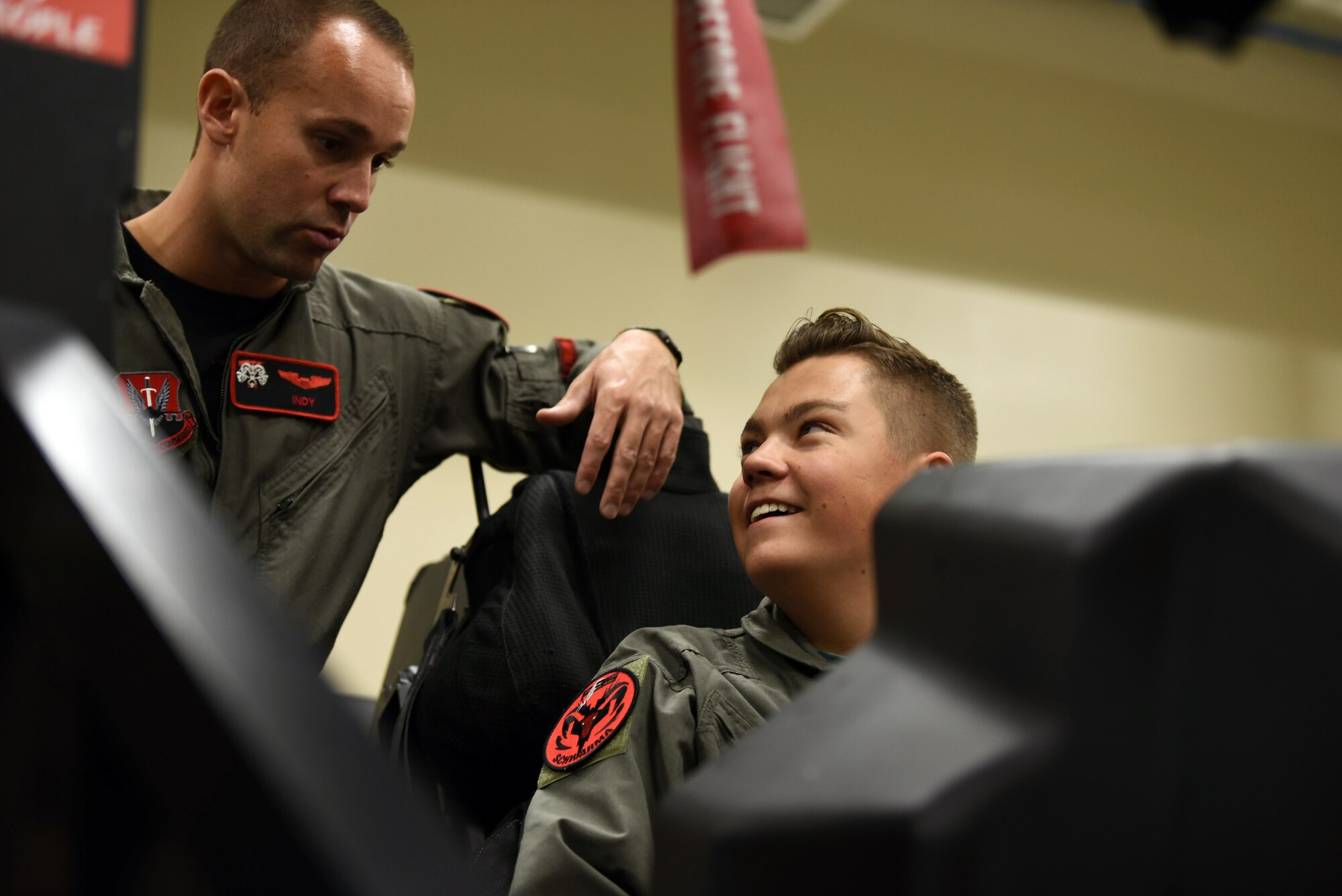 Ethan, with Make-A-Wish Utah is briefed by Capt. Buck Horn in an F-35A Lightning II egress trainer at Hill Air Force Base, Utah. A group of children visited the 388th Fighter Wing where they spent the day learning what it's like to be a pilot. They received flight suits, name tapes, patches, and wings. (U.S. Air Force photo by Micah Garbarino)