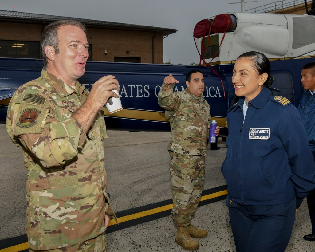 U.S. Air Force Tech. Sgt. David Prato, 1st Helicopter Squadron UH-1N special missions aviator instructor, talks with a cadet from the Latin American Cadet Initiative during a tour on Joint Base Andrews, Md., Oct. 16, 2019.