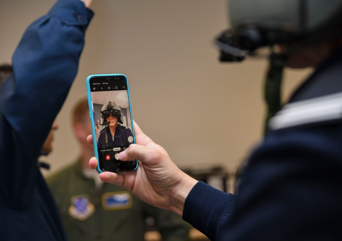 A cadet captures a photo of himself with a HGU-56/P helmet on during a 1st Helicopter Squadron tour with the Latin American Cadet Initiative on Joint Base Andrews, Md., Oct. 16, 2019.
