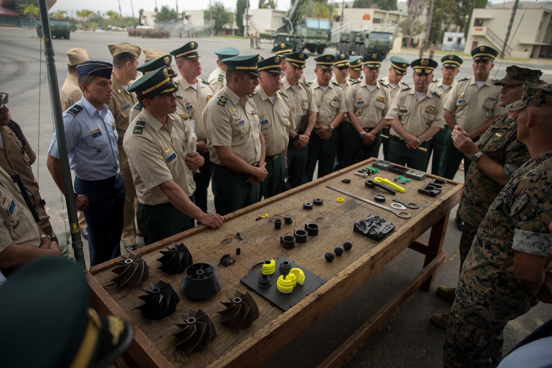 U.S. Marine Corps Col. Jaime Collazo, the commanding officer of Combat Logistics Regiment 15, 1st Marine Logistics Group, presents products from an expeditionary manufacturing trailer to the students from the Colombian War College’s General Staff Course at Camp Pendleton, Calif., Sept. 6, 2017. In addition to the War College’s academic master’s program, the school offers specialist degrees in security and national defense, command and general-staff studies, and the promotion courses for high-ranking military officers.