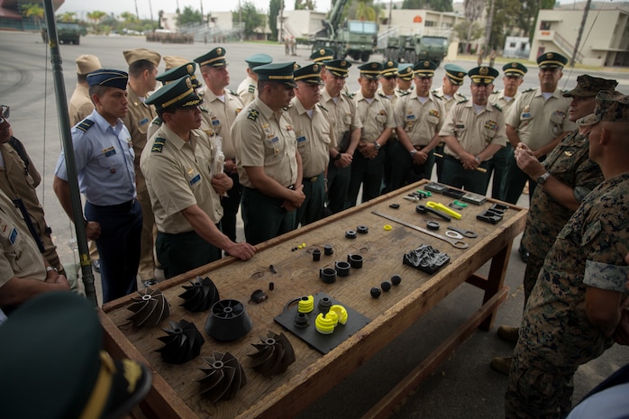 U.S. Marine Corps Col. Jaime Collazo, the commanding officer of Combat Logistics Regiment 15, 1st Marine Logistics Group, presents products from an expeditionary manufacturing trailer to the students from the Colombian War College’s General Staff Course at Camp Pendleton, Calif., Sept. 6, 2017. In addition to the War College’s academic master’s program, the school offers specialist degrees in security and national defense, command and general-staff studies, and the promotion courses for high-ranking military officers.