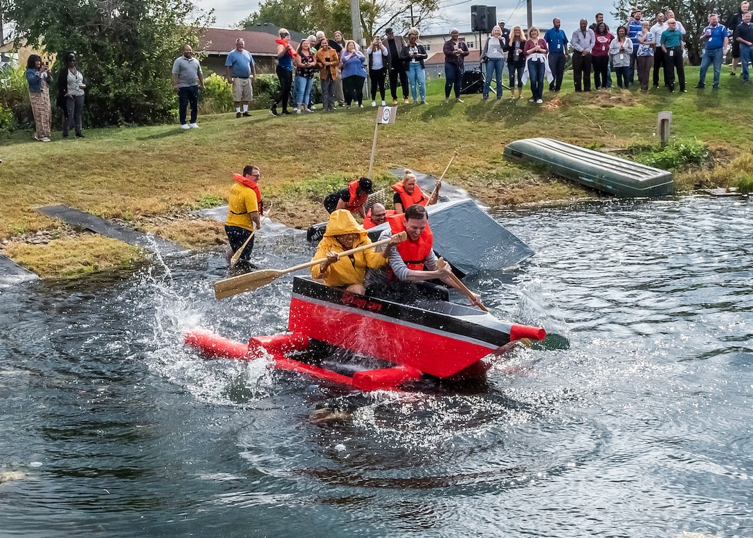 two people paddle a boat through the water.