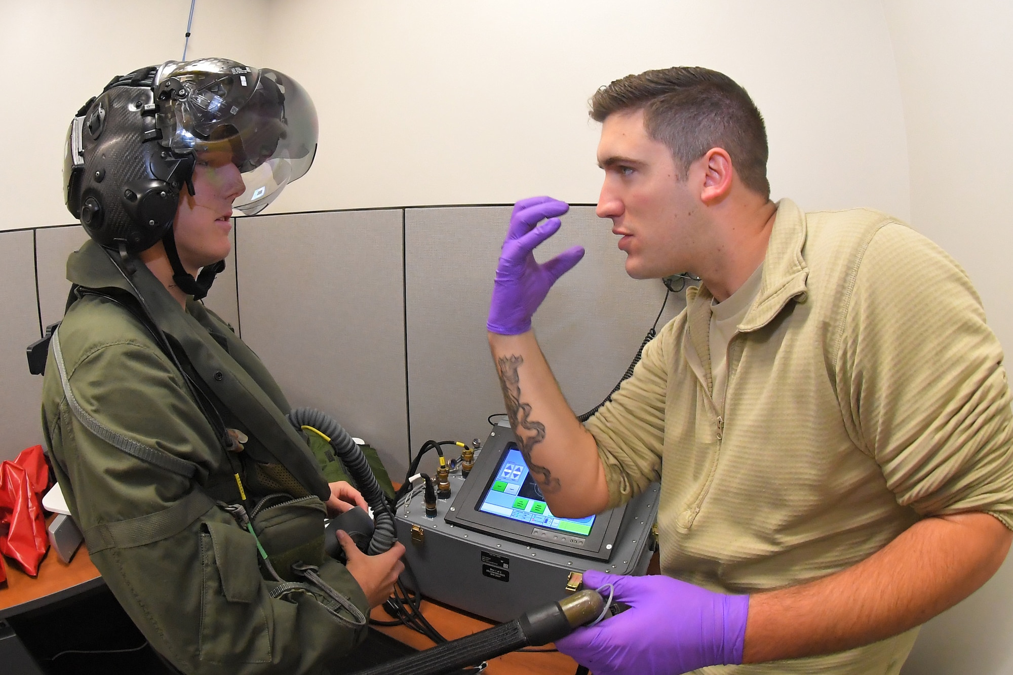 Senior Airman Ian Smith, right, an Aircrew Flight Equipment Journeyman with the 388th Operations Support Squadron demonstrates an F-35A Lightning II helmet heads up display for Pearce, a "wish kid" with Make-A-Wish Utah. A group of children visited the 388th Fighter Wing at Hill Air Force Base, Utah, where they spent the day learning what it's like to be a pilot. (U.S. Air Force photo by Micah Garbarino) (U.S. Air Force photo by Todd Cromar)