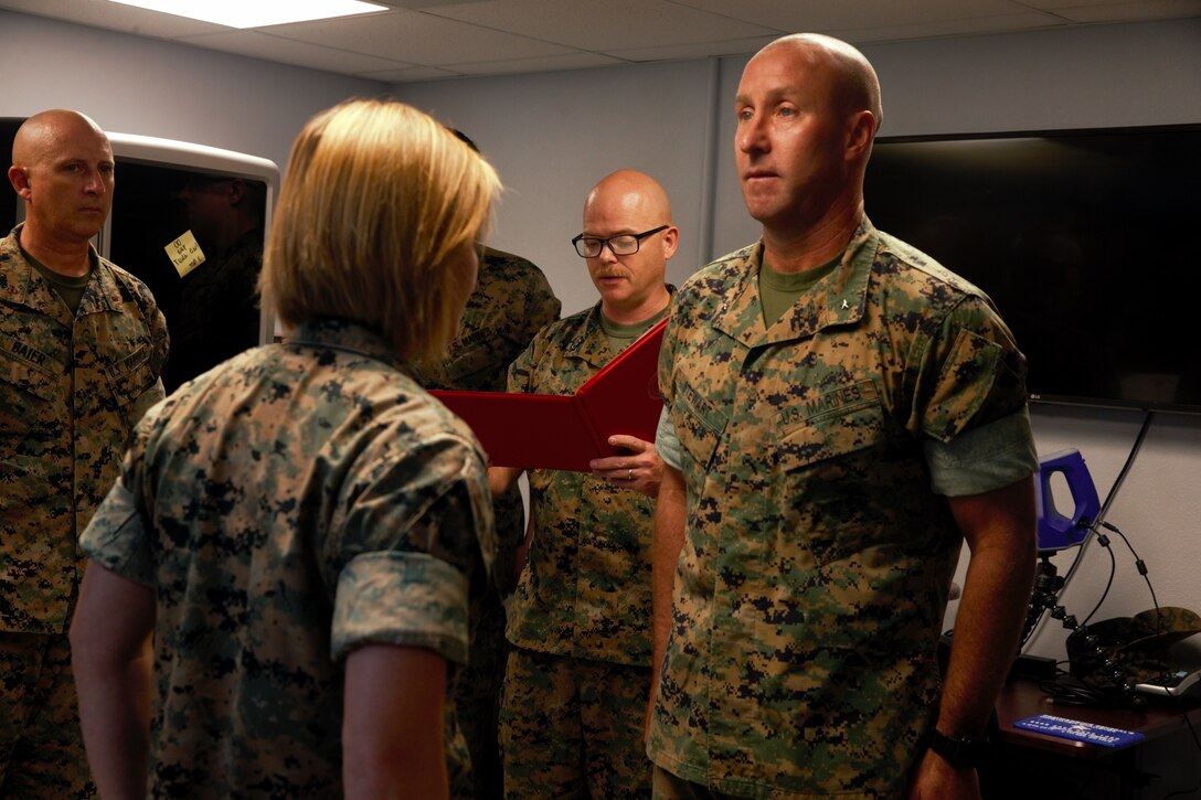 U.S. Marine Staff Sgt. Elissa Pedelty receives $1,000 and a Navy and Marine Corps Achievement Medal for her winning idea in designing an Environmental Control Unit (ECU) duct cover at MakerSpace, Camp Lejeune, North Carolina, on Oct. 16, 2019. MakerSpace facilitates the 2nd Marine Logistics Group Commanding General’s Innovation Challenge, where Marines and Sailors submit innovative ideas to design an interesting culture that explores new ideas to improve policies, procedures or products.  (U.S. Marine Corps photo by Sgt. Ashley Lawson)