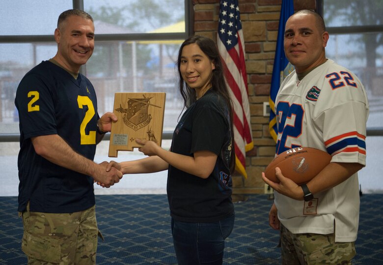 Senior Airman Nicole Henao, 49th Medical Group 3rd quarter award winner, accepts the Airman of the Quarter award during the 49th Wing’s 3rd quarter award ceremony, Oct. 18, on Holloman Air Force Base, N.M. Quarterly award winners were selected based on their technical expertise, demonstration of leadership and job performance. (U.S. Air Force photo by Airman 1st Class Quion Lowe)