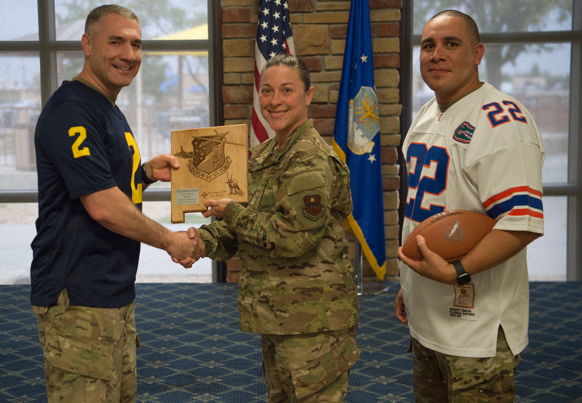 Tech. Sgt. Jennifer Johnson, 49th Mission Support Group 3rd quarter award winner, accepts the Noncommissioned Officer of the Quarter award during the 49th Wing’s 3rd quarter award ceremony, Oct. 18, on Holloman Air Force Base, N.M. Quarterly award winners were selected based on their technical expertise, demonstration of leadership and job performance. (U.S. Air Force photo by Airman 1st Class Quion Lowe)