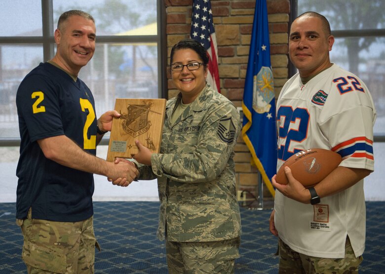 Master Sgt. Silvia Ingram, 49th Medical Group 3rd quarter award winner, accepts the Senior Noncommissioned Officer of the Quarter award during the 49th Wing’s 3rd quarter award ceremony, Oct. 18, on Holloman Air Force Base, N.M. Quarterly award winners were selected based on their technical expertise, demonstration of leadership and job performance. (U.S. Air Force photo by Airman 1st Class Quion Lowe)