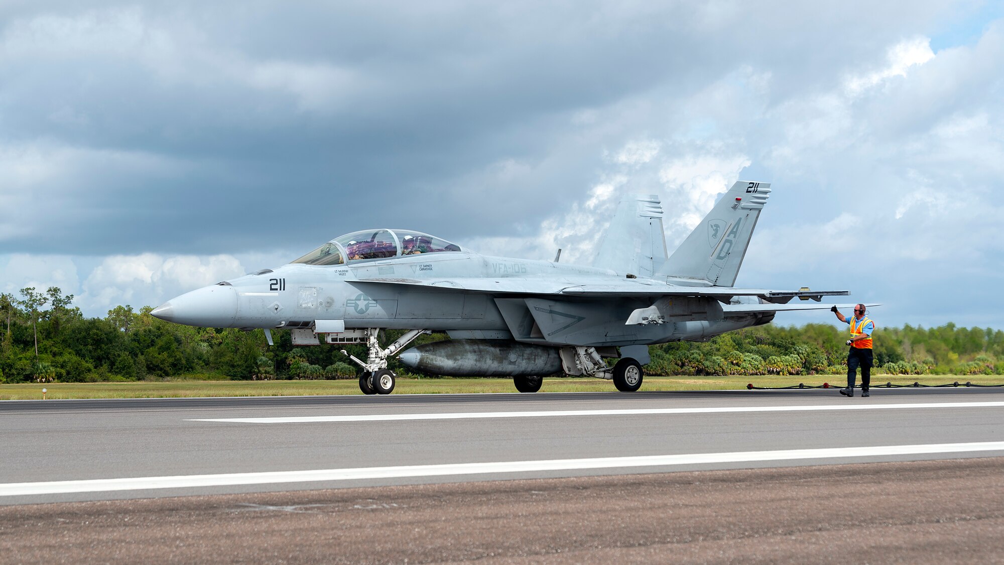 A U.S. Air Force firefighter signals the pilot of a U.S. Navy Strike Fighter Squadron 106 F/A-18F Super Hornet aircraft after an arrested landing at MacDill Air Force Base, Fla., Oct 16, 2019. Arrested landings allow pilots to achieve rapid deceleration when landing aboard an aircraft carrier by attaching a tailhook to a cable, which absorbs the energy of the aircraft.