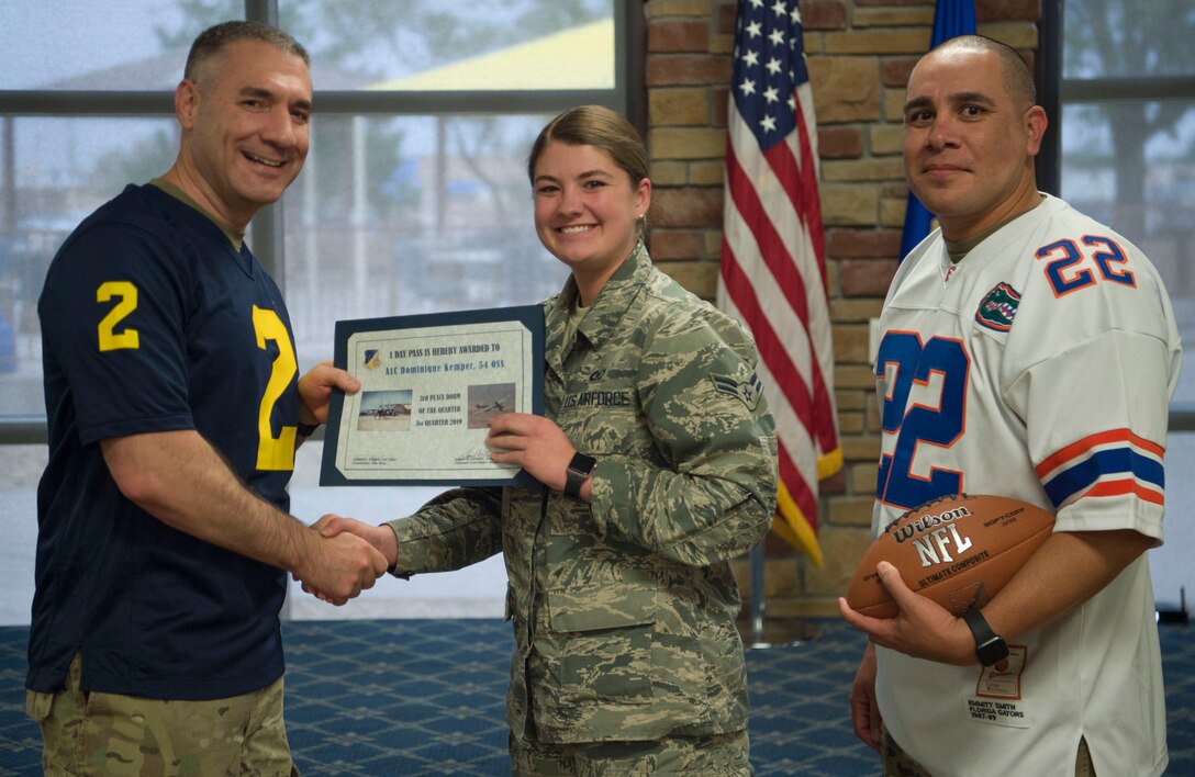 Airman 1st Class Dominique Kemper, 54th Fighter Group member, accepts the 3rd place Dorm Resident of the Quarter award during the 49th Wing’s 3rd quarter award ceremony, Oct. 18, on Holloman Air Force Base, N.M. Quarterly award winners were selected based on their technical expertise, demonstration of leadership and job performance. (U.S. Air Force photo by Airman 1st Class Quion Lowe)