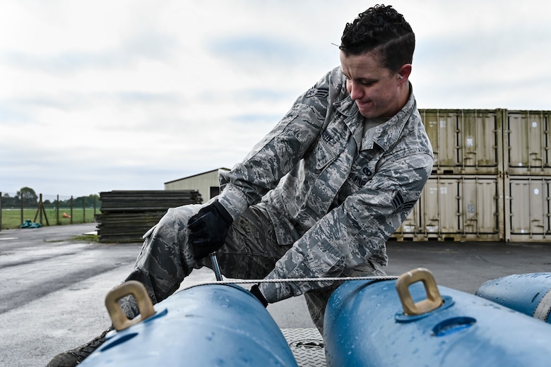 Senior Airman ensures the cap on a BDU-50 is secure