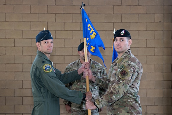U.S. Air Force Lt. Col. James Kappes (left), 6th Combat Training Squadron operations officer, Camp Bullis, presents the Detachment 2, Combat Training Squadron guidon to Capt. Daniel Hill (right), incoming commander, during the activation ceremony Sept. 17, 2019, at Joint Base San Antonio-Medina Annex, Texas.