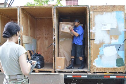 1st Lt. Kathryn Bailey, a Blackhawk pilot with the 2nd Battalion, 25th Aviation Regiment, 25th Combat Aviation Brigade, 25th Infantry Division, supervises the delivery and unpacking of her household items May 11 on Wheeler Army Airfield, Hawaii.