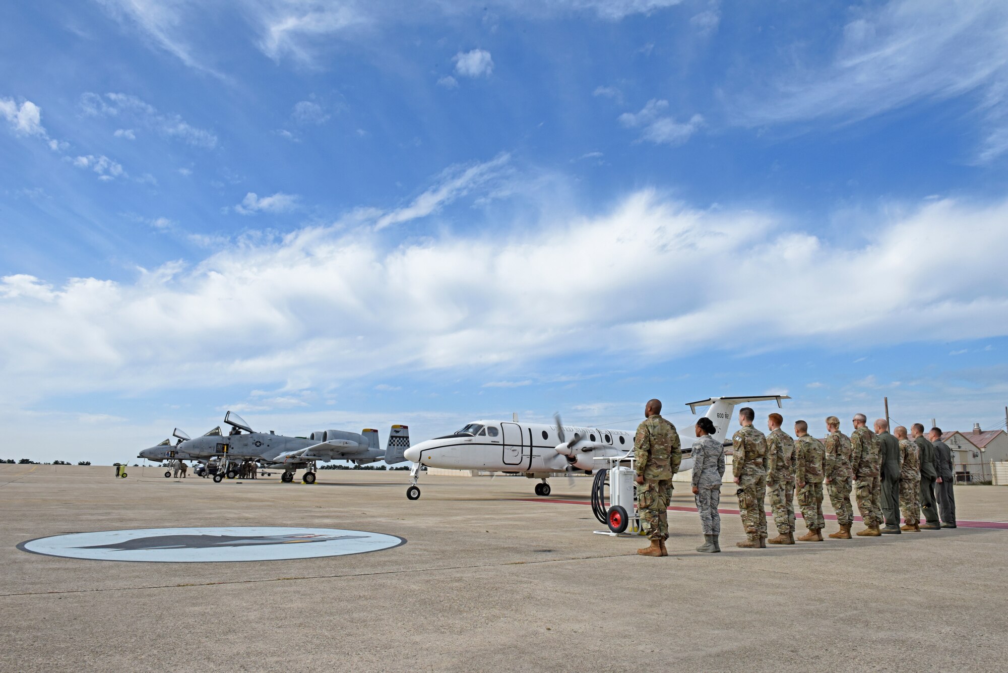 Members of the Wolf Pack stand at attention during the departure of U.S. Air Force Gen. CQ Brown, Jr. Pacific Air Forces commander, from Kunsan Air Base, Republic of Korea, Oct. 18, 2019. Brown was stationed at Kunsan from April 1987 to October 1988 as a first lieutenant and then again from May 2007 to May 2008, where he led the Wolf Pack as “Wolf 46.” (U.S. Air Force photo by Staff Sgt. Mackenzie Mendez)