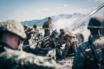 Philippine Marines with the 17th Marine Corps Field Artillery Battalion observe U.S. Marines with Alpha Battery, Battalion Landing Team 3/5, 11th Marine Expeditionary Unit, during a fire mission at Colonel Ernesto Ravina Air Base, Philippines, as part of exercise KAMANDAG 3, Oct. 13, 2019. KAMANDAG advances military modernization and capability development through subject matter expert exchanges.
