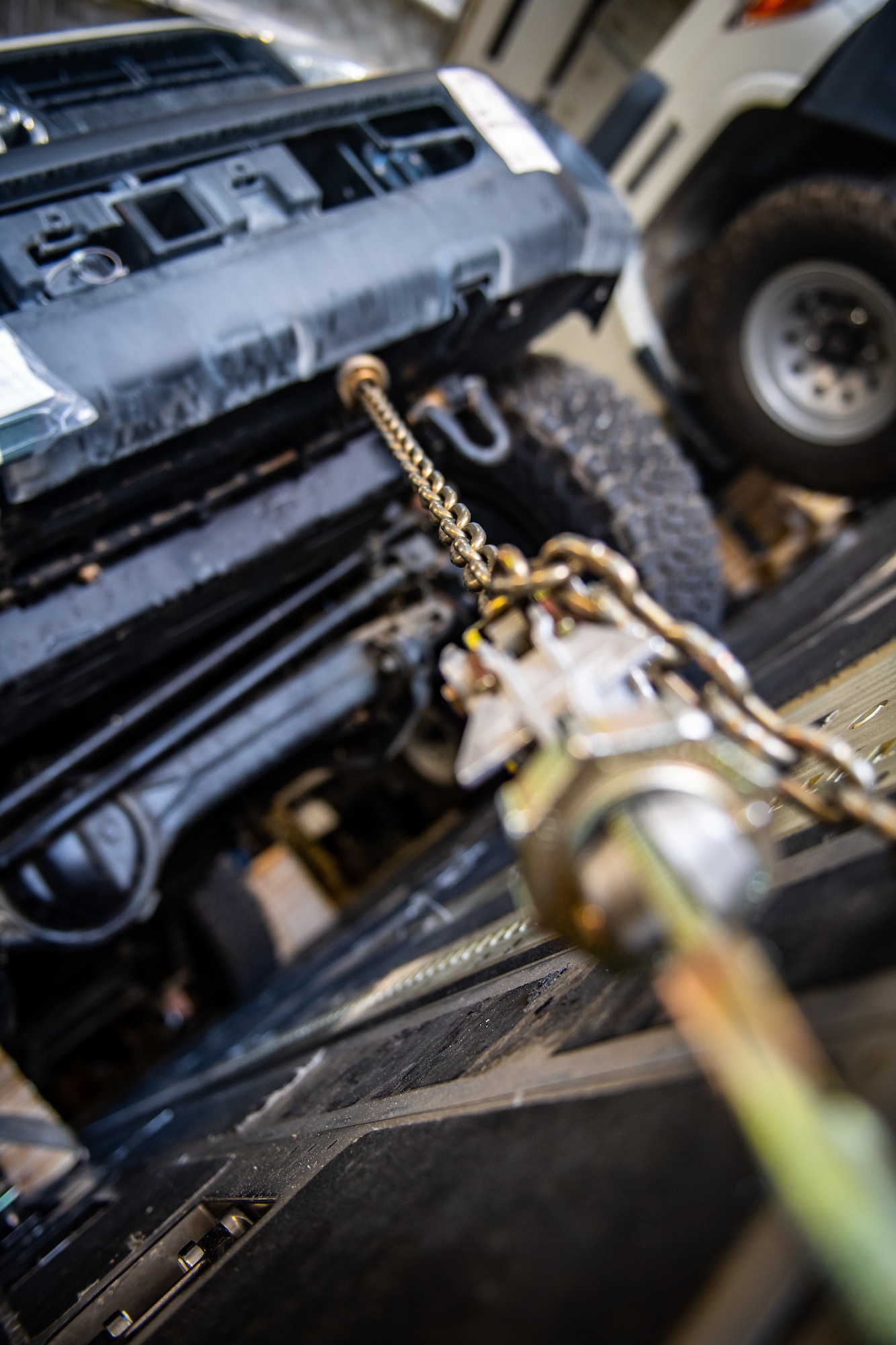 Chains used to secure cargo inside a U.S. Air Force C-17 Globemaster III during flight are disconnected prior to unloading in Jordan, Oct. 14, 2019.