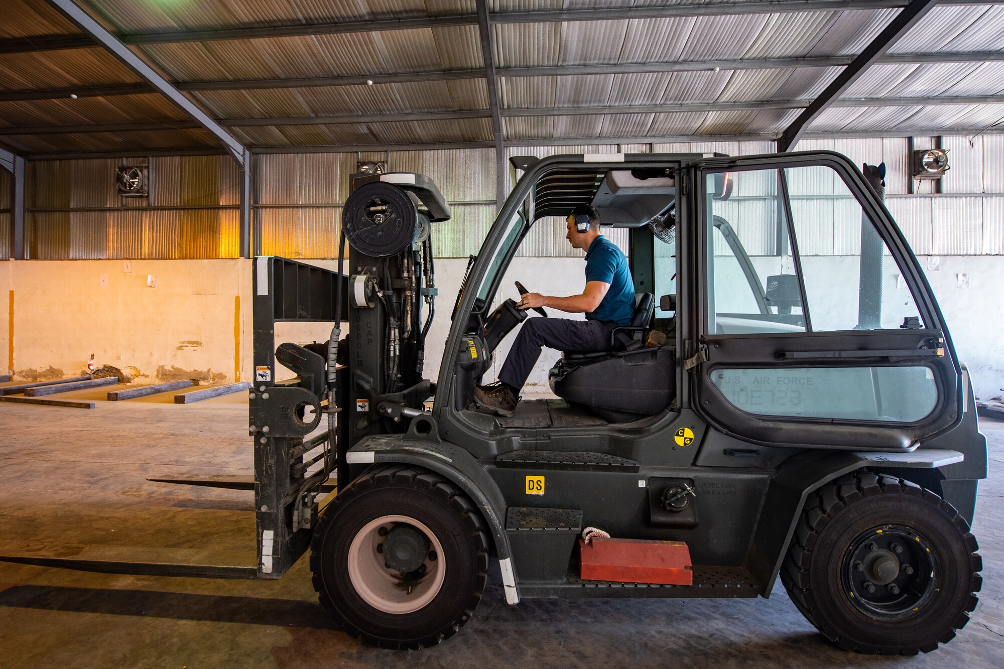 Staff Sgt. Tony Bellow, NCO-in-charge of Cargo Operations, Jordan Port, 387th Air Expeditionary Squadron, operates a fork-lift inside a warehouse while positioning cargo for future movements in Jordan, Oct. 14, 2019.