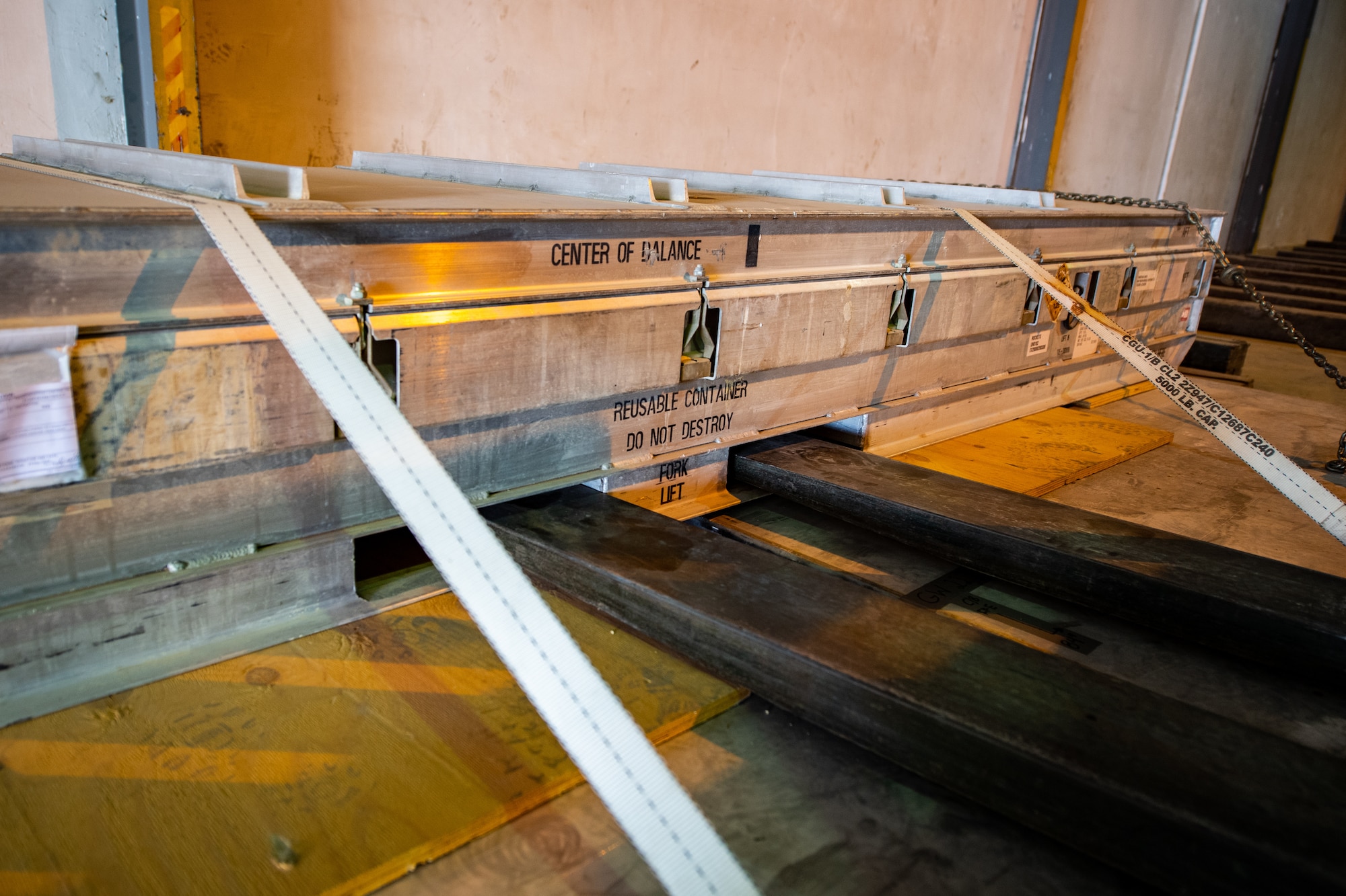 A forklift picks up cargo inside a warehouse.