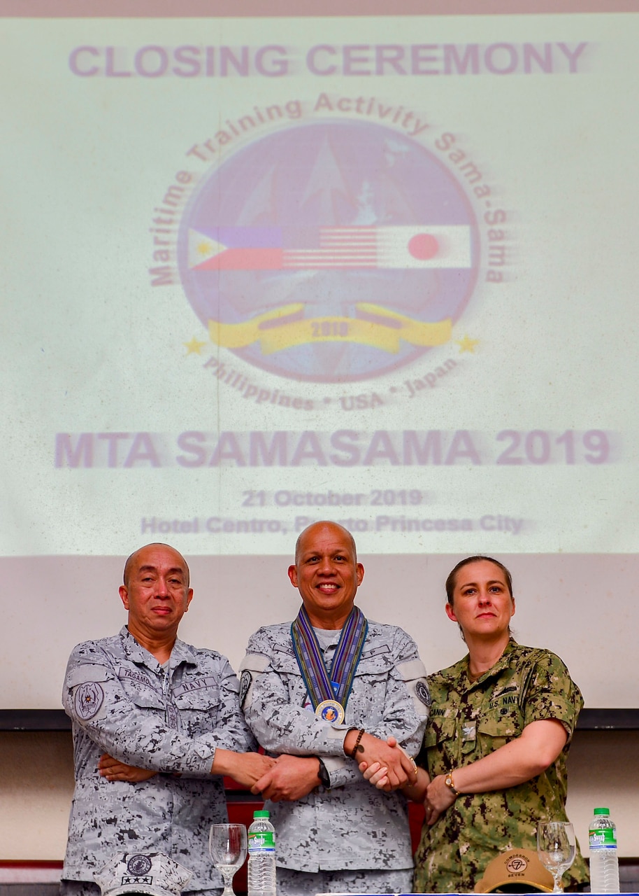 PUERTO PRINCESA, Philippines (Oct. 21, 2019) - (From left to right) Philippine Navy Capt. Francisco Tagamolila Jr., acting commander, Philippine Naval Forces West, Philippine Navy Vice Adm. Rene Medina, commander, Western Command, and U.S. Navy Capt. Ann McCann, deputy commodore of Destroyer Squadron 7, pose for a photo after the closing ceremony for Maritime Training Activity (MTA) Sama Sama 2019. Now in its third year, MTA Sama Sama includes forces from Japan, Philippines and the United States, and is designed to promote regional security cooperation, maintain and strengthen maritime partnerships, and enhance maritime interoperability.