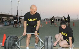 Sgt. 1st Class John Santos, 1st Theater Sustainment Command (TSC), helps prepare equipment for the 3 repetition maximum deadlift event of the Army Combat Fitness Test (ACFT) at Camp Arifjan, Kuwait, Oct. 16, 2019. Sgt. 1st Class John Santos established this program to help expand the force of ACFT administrators and graders throughout Camp Arifjan. Since June, 2019, Santos has trained about 225 Soldiers to administer the ACFT.