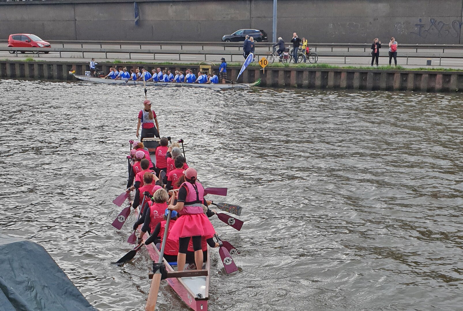 a dragon boat team paddles in the water