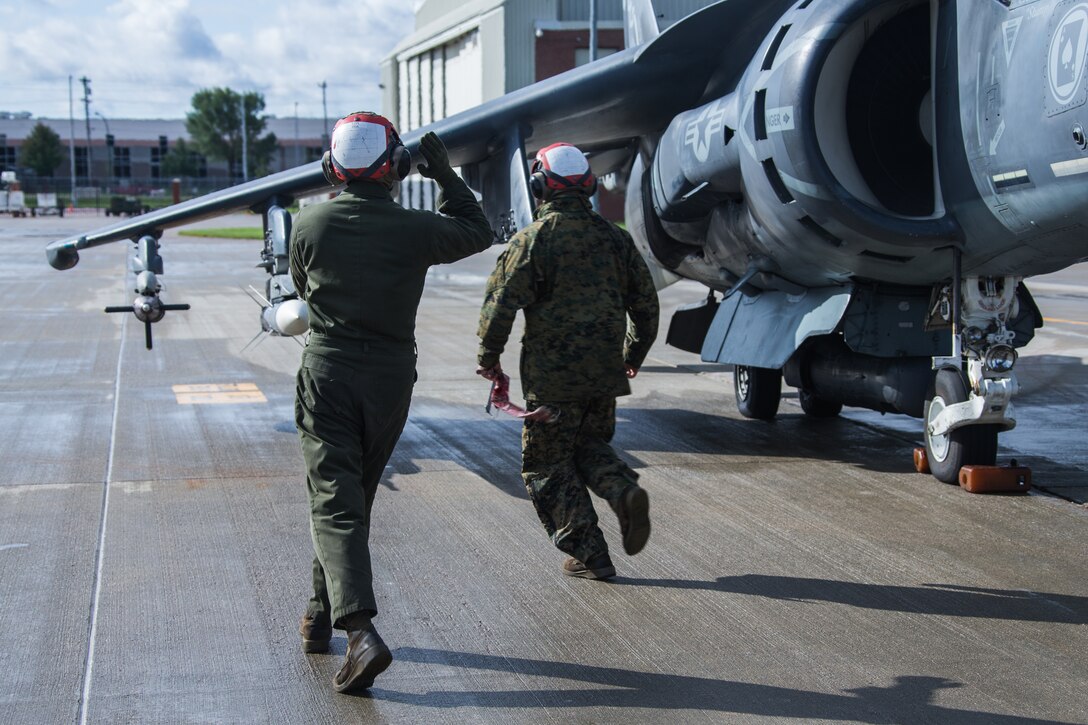 Lance Cpl. Fabian Vigil (left) and Lance Cpl. Jacob A. Fox prepare an AV-8B II Harrier attack jet for take-off during a training mission with the 175th Fighter Squadron, 114th Fighter Wing at Joe Foss Field, Sioux Falls, S.D, Oct. 5, 2019. Marine Attack Squadron 231 and 175th FS, 114th FW are participating in force-on-force training consisting of simulated air-to-air combat and air-to-ground strikes to enhance interoperability and readiness. Fabian and Fox are aircraft ordnance technicians with VMA-231. (U.S. Marine Corps photo by Lance Cpl. Gavin Umboh)