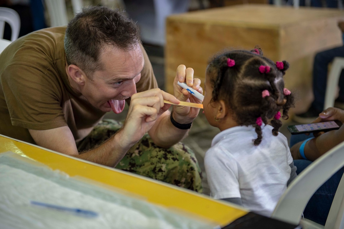 A U.S. Navy doctor examines a child.