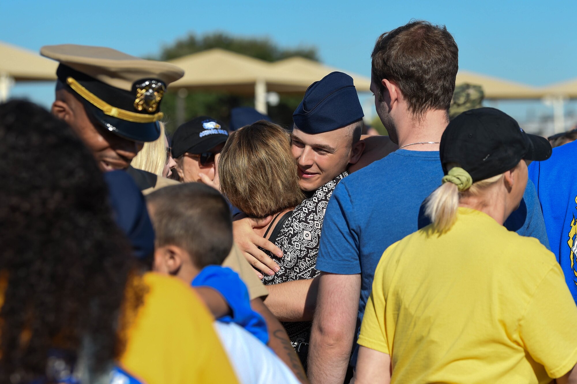 A U.S. Air Force basic military training graduate embraces one of their visitors after marching in their graduation parade on Lackland Air Force Base, Texas, Oct. 18, 2019. After the graduation parade where new graduates march across the enlisted heroes walk, they are released to their families and visitors for the day.