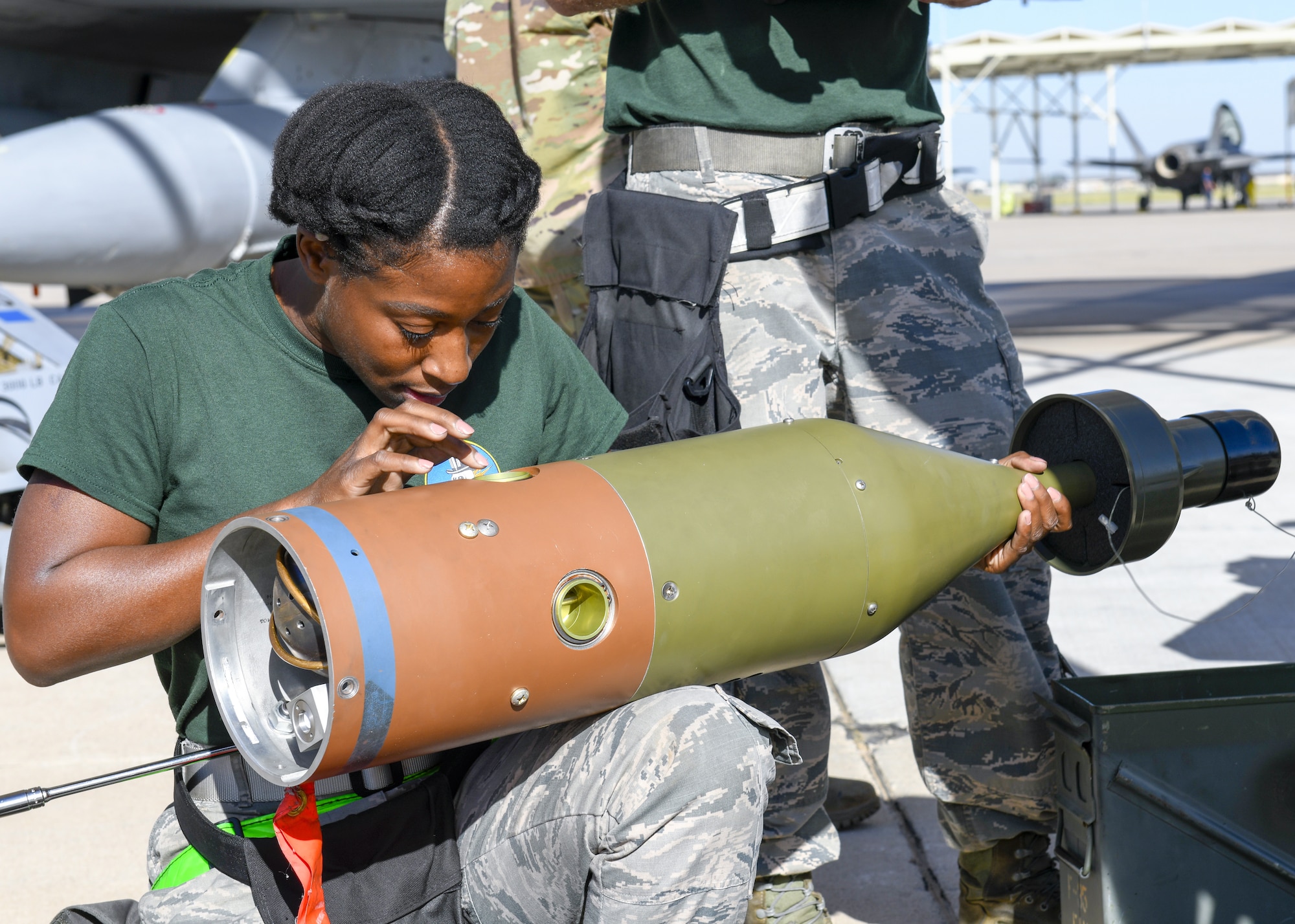 Senior Airman Felicia Richmond, 310th Aircraft Maintenance Unit weapons load crew member, inspects an inert bomb during the 3rd Quarter Load Crew Competition Oct. 17, 2019, at Luke Air Force Base, Ariz.