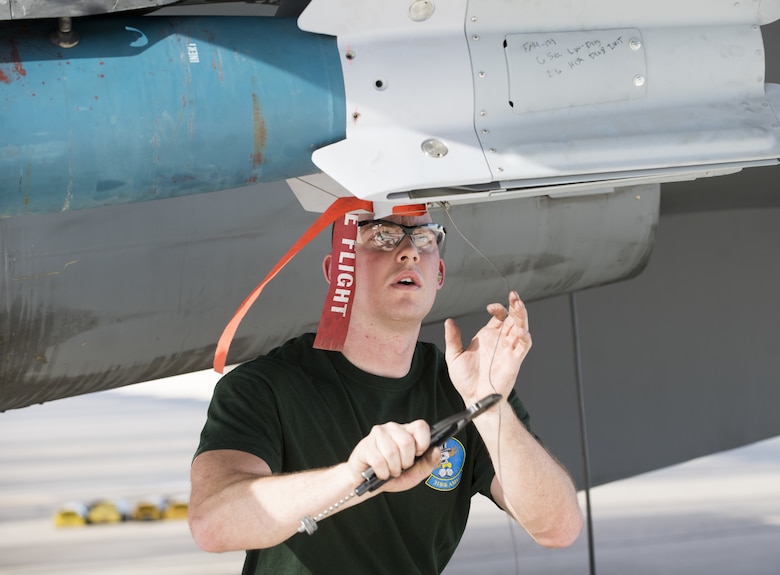 Senior Airman Jordan Varney, 310th Aircraft Maintenance Unit weapons load crew member, prepares a munition on an F-16C Fighting Falcon during the 3rd Quarter Load Crew Competition Oct. 17, 2019, at Luke Air Force Base, Ariz.
