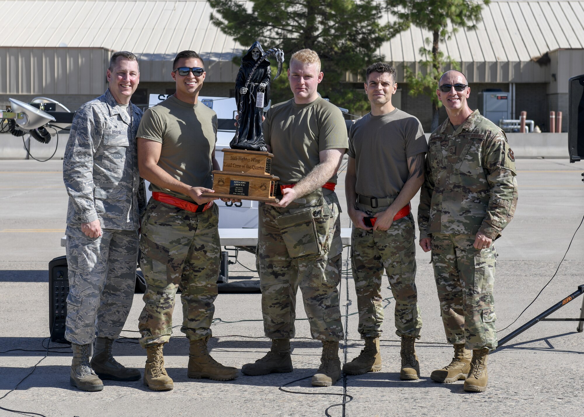 Members from the 63rd Aircraft Maintenance Unit accept a trophy after winning the 3rd Quarter Load Crew Competition Oct. 17, 2019, at Luke Air Force Base, Ariz.