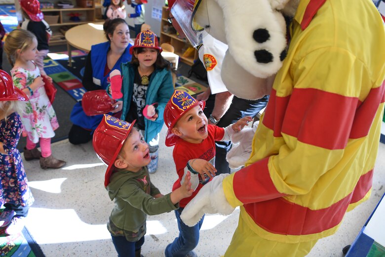 Sparky the Dog visits with children during Fire Prevention Week in the Child Development Center at Schriever Air Force Base, Colorado, Oct. 11, 2019.