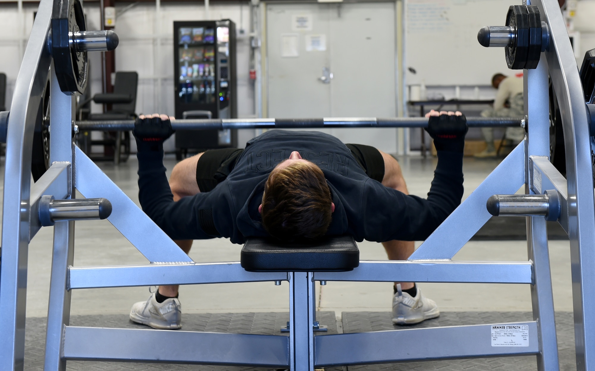 Airman 1st Class Carl, 22nd Attack Squadron sensor operator, performs bench presses in the Reaper Fitness Center at Creech Air Force Base, Nevada, Oct. 16, 2019. The Reaper Fitness Center is being renovated with male and female restrooms that include showers. (U.S. Air Force photo by Airman 1st Class William Rio Rosado)