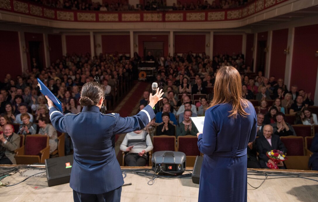 U.S. Air Force Lt. Col Cristina Moore Urrutia, U.S. Air Forces in Europe Ambassadors Jazz Band commander and conductor, greets the audience while Maria Lebovka, media manager and interpreter for the band’s Ukraine tour, translates her greeting during a concert with the USAFE Band and the Ukrainian National Presidential Orchestra at the Philharmonic in Chernivisti, Ukraine, Oct. 12, 2019. The USAFE Band traveled to six cities in central and western Ukraine October 6-20, 2019 to conduct the “Music of Freedom” tour, which celebrated the shared spirit of freedom and enduring partnership between U.S. and Ukrainian armed forces. (U.S. Air Force photo by Airman 1st Class Jennifer Zima)