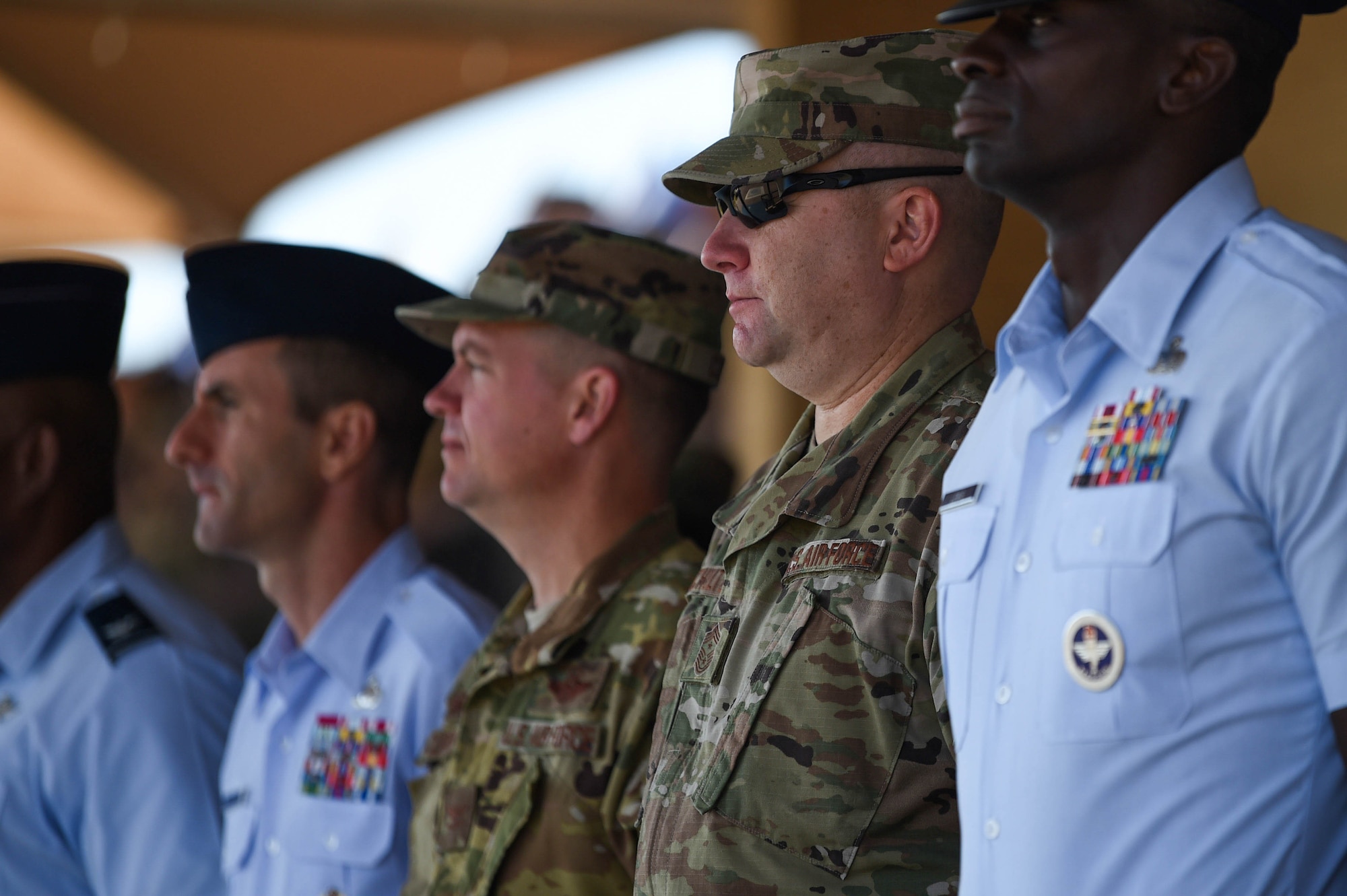 Col. Scovill Currin, 62nd Airlift Wing commander, second from left, and Chief Master Sgt. Rob Schultz, 62nd Airlift Wing command chief, third from left, observe a basic military training graduation parade on Lackland Air Force Base, Texas, Oct. 18, 2019. New basic military training graduates march in the graduation parade across the enlisted heroes walk at the end of their eight weeks of demanding training.