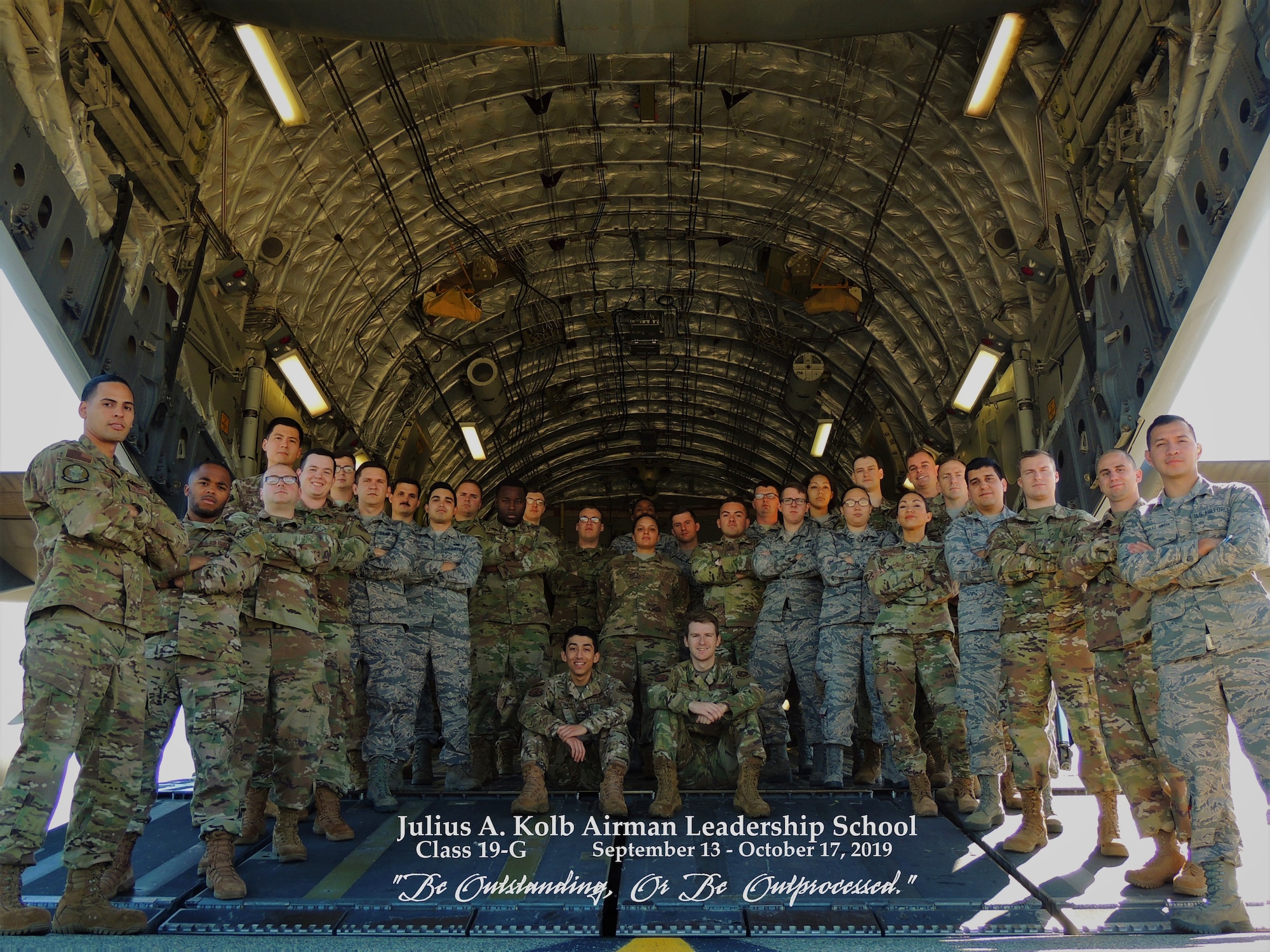 Graduates of ALS Class 19-G pose for a photo in the back of a C-17