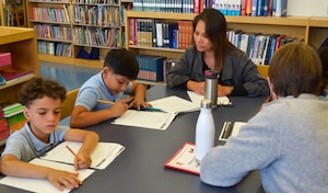 DLA Troop Support employees help students with schoolwork during the initial Project G.I.V.E. tutoring session for the 2019-2020 school year at the Benjamin Franklin Elementary School Oct. 15, 2019 in Philadelphia.