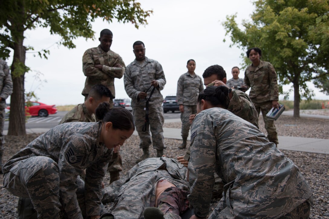 Airmen prepare a simulated casualty to be transported via stretcher, Sept 16, 2019, at Mountain Home AFB, Idaho. The simulation mannequin is not only capable of simulating combat wounds, but is also weighted to give even more realism to the simulation. (U.S. Air Force photo by Airman 1st Class Nicholas Swift)