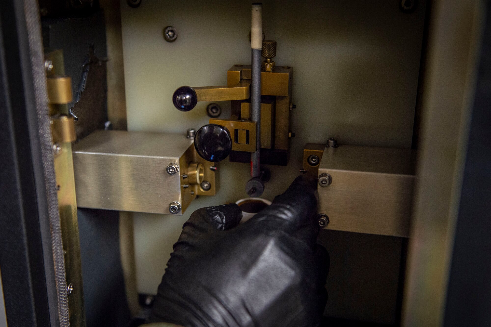 Airman 1st Class Luis Perez-Lugo, 23d Maintenance Squadron (MXS) nondestructive inspection journeyman, places oil onto a sample holder during an inspection Oct. 21, 2019, at Moody Air Force Base, Ga. Joint oil analysis inspections are performed after each aircraft flight to detect abnormal wear of an aircraft engine and prevent catastrophic failure. The 23d MXS Airmen use an oil analysis spectrometer fitted with a carbon rod and disc to determine the concentration of elements, such as zinc and iron, present within the engine parts. (U.S. Air Force photo by Airman Azaria E. Foster)
