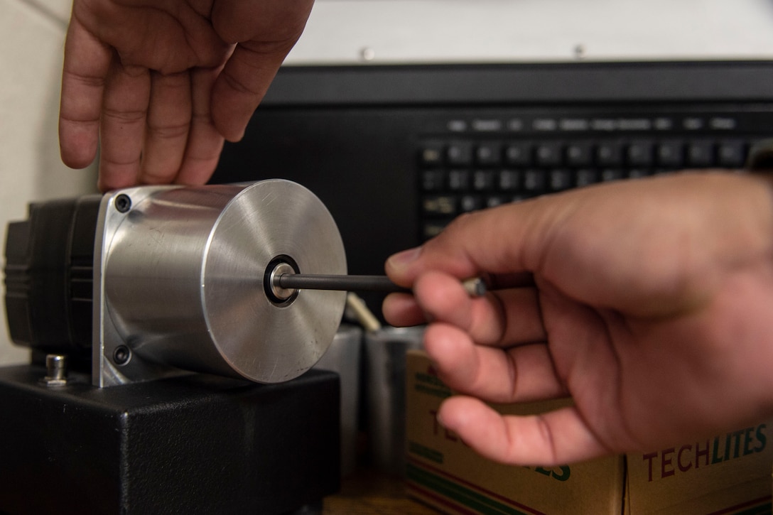 Airman 1st Class Luis Perez-Lugo, 23d Maintenance Squadron (MXS) nondestructive inspection journeyman, sharpens a carbon rod during a joint oil analysis inspection Oct. 21, 2019, at Moody Air Force Base, Ga. Joint oil analysis inspections are performed after each aircraft flight to detect abnormal wear of an aircraft engine and prevent catastrophic failure. The 23d MXS Airmen use an oil analysis spectrometer fitted with a carbon rod and disc to determine the concentration of elements, such as zinc and iron, present within the engine parts.  (U.S. Air Force photo by Airman Azaria E. Foster)