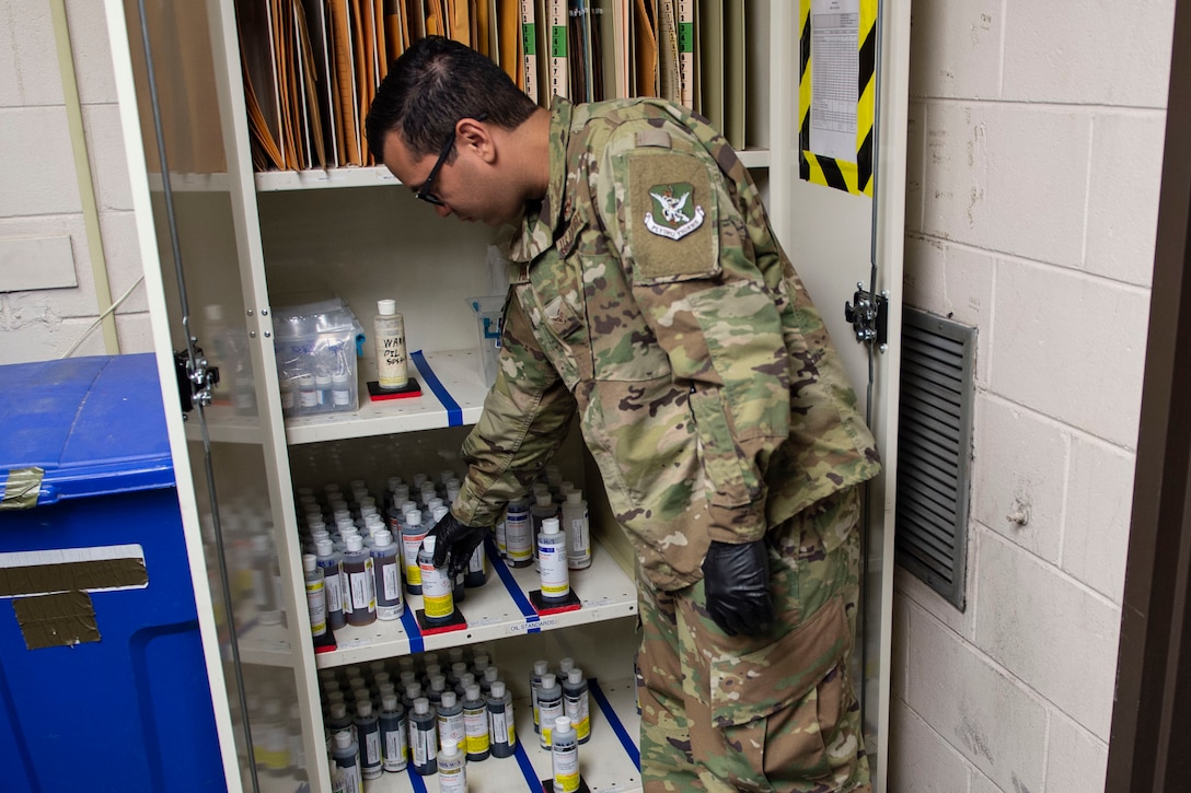 Airman 1st Class Luis Perez-Lugo, 23d Maintenance Squadron (MXS) nondestructive inspection journeyman, grabs an oil sample during a joint oil analysis inspection Oct. 21, 2019, at Moody Air Force Base, Ga. Joint oil analysis inspections are performed after each aircraft flight to detect abnormal wear of an aircraft engine and prevent catastrophic failure. The 23d MXS Airmen use an oil analysis spectrometer fitted with a carbon rod and disc to determine the concentration of elements, such as zinc and iron, present within the engine parts. (U.S. Air Force photo by Airman Azaria E. Foster)