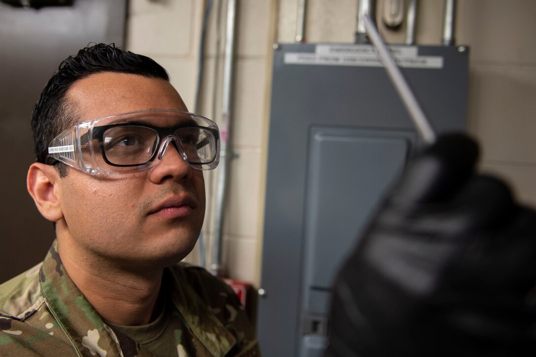 Airman 1st Class Luis Perez-Lugo, 23d Maintenance Squadron (MXS) nondestructive inspection journeyman, examines a carbon rod during a joint oil analysis inspection Oct. 21, 2019, at Moody Air Force Base, Ga. Joint oil analysis inspections are performed after each aircraft flight to detect abnormal wear of an aircraft engine and prevent catastrophic failure. The 23d MXS Airmen use an oil analysis spectrometer fitted with a carbon rod and disc to determine the concentration of elements, such as zinc and iron, present within the engine parts. (U.S. Air Force photo by Airman Azaria E. Foster)