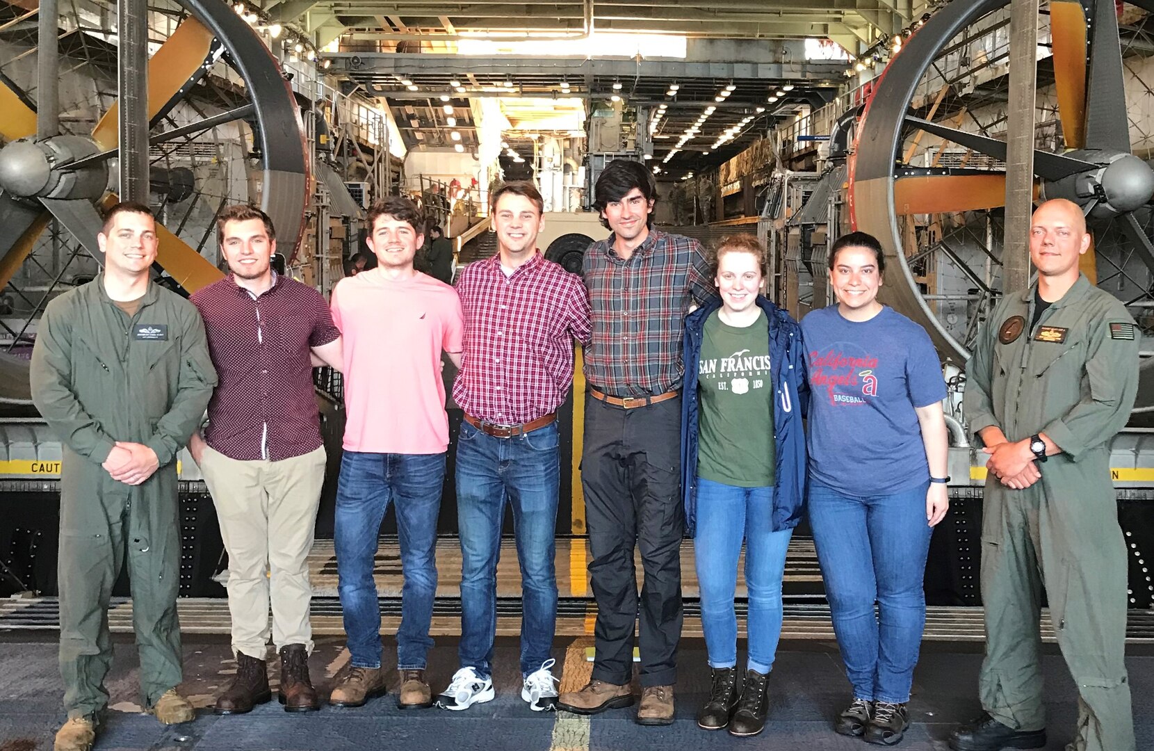 IMAGE: USS CARTER HALL (April 30, 2019) – Six members of the Naval Surface Warfare Center Dahlgren Division (NSWCDD) Sly Fox Mission 26 team are pictured with Sailors in front of a Landing Craft Air Cushion vehicle aboard USS CARTER HALL (LSD 50). Over the course of a one-week deployment, the Sly Fox Mission 26 team collaborated with the Carter Hall crew while studying operations throughout the ship to develop a system called PERSEUS that lays the groundwork for solving power management in the future Navy.  (U.S. Navy photo/Released)