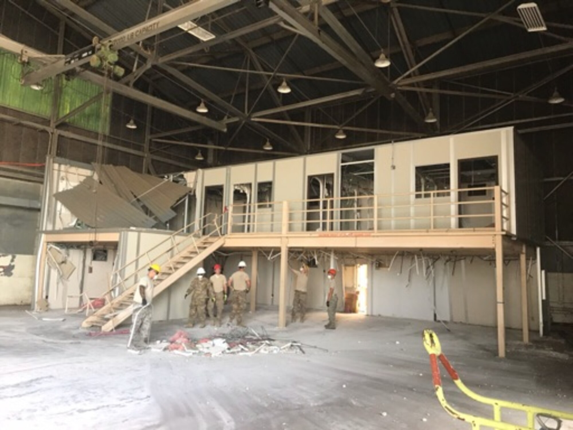 Airmen from the 60th Civil Engineer Squadron demolish old mobile offices inside Building 844 at Travis Air Force Base, California, July 2, 2019. The refurbished hangar houses the new Nose Dock Gym, facilitated through existing base funds, equipment donations and volunteer work by the 60th Mission Support Group. (U.S. Air Force courtesy photo)