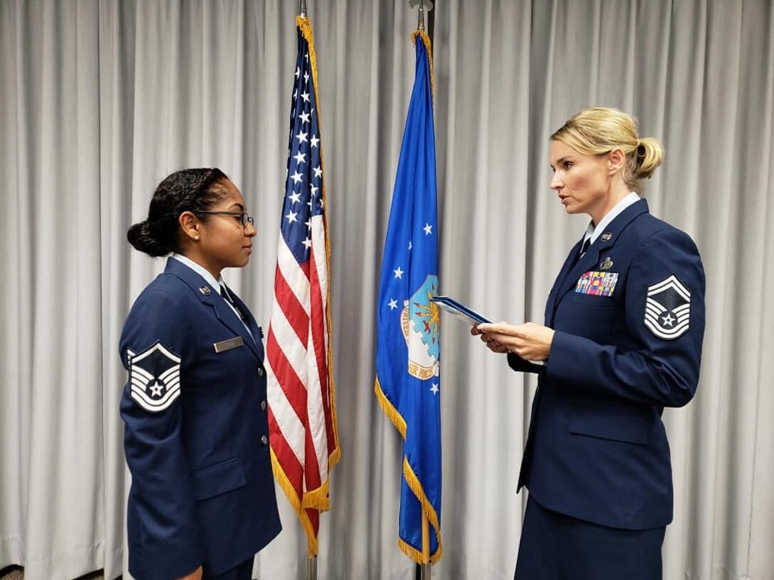 Senior Master Sgt. Laura Garcia, 340th FTG Military Personnel Section superintendent, administers the SNCO oath to new SNCO corps inductee, Master Sgt. Natasha Todd, September 6 at Joint Base San Antonio-Randolph, Texas. (U.S. Air Force photo by Debbie Gildea)