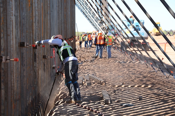 A U.S. Army Corps of Engineers Task Force Barrier contractor prepares the bottom of the steel bollard barrier panels for concrete placement near Columbus, N.M., Sept. 23, 2019. USACE is providing direction and oversight of Department of Defense (DoD)-funded construction of barrier system projects along the southwest border. These projects are being executed by USACE, as directed through the U.S. Army by the Secretary of Defense, in response to Department of Homeland Security’s request for assistance to help secure the United States southern border by blocking drug-smuggling corridors through the construction of roads and fences, and the installation of lighting under the Title 10, section 284 of the U.S. Code. DoD and USACE are executing these projects in support of U.S. Customs and Border Protection.