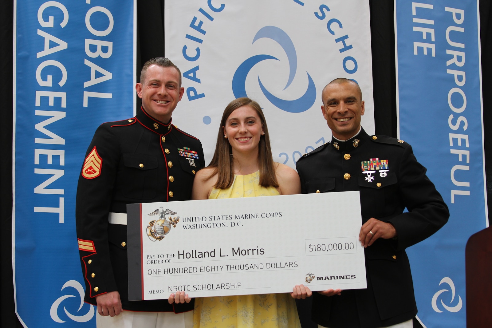 U.S. Marine Corps Maj. Jared Reddinger and Gunnery Sgt. Bradley Phillips present Holand Morris the Naval Reserve Officers Training Corps scholarship on May 16, 2019. The NROTC scholarship grants young men and women full scholarships to the school of their choosing. While attending school they will complete Officer Candidates School and upon graduation they will commission as an officer.