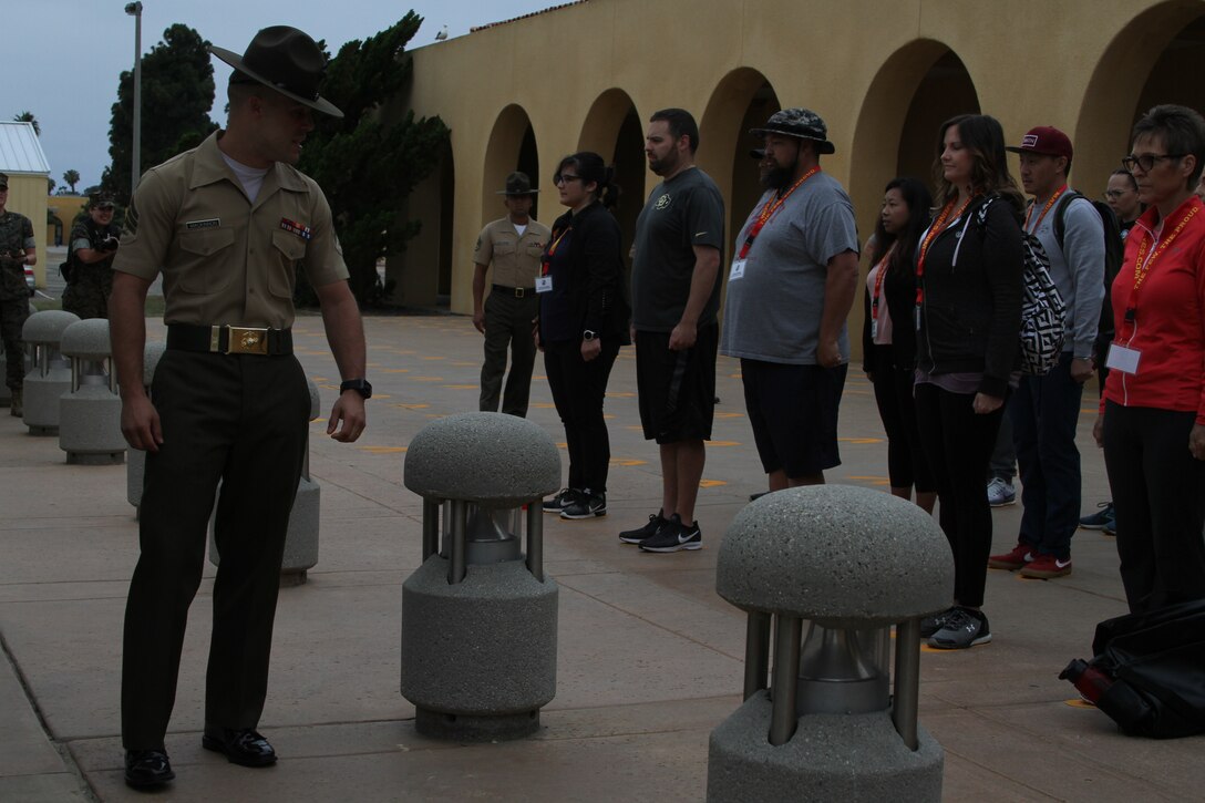 Educators from the San Diego area stand on the Yellow Footprints during the Educators' Workshop at Marine Corps Recruit Depot San Diego, Calif., June 17, 2019. The Educators' Workshop provides and in-depth experience about the transformation young men and women go through on their journey to claim the title Marine.