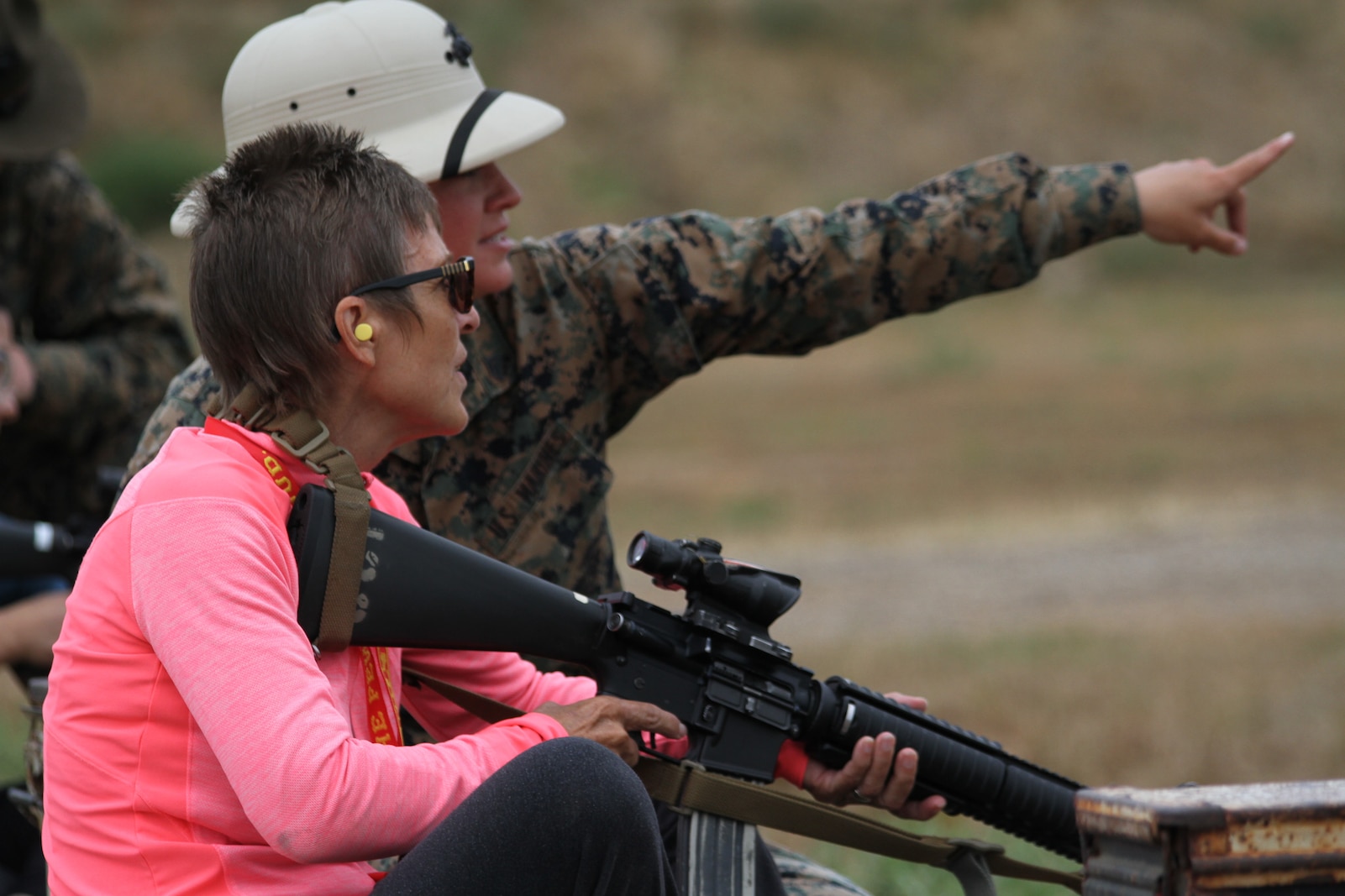An educator from the San Diego area receives instructions from a U.S. Marine Combat Marksmanship Coach during the Educators' Workshop at Camp Pendleton, June 17, 2019. The Educators' Workshop provides and in-depth experience about the transformation young men and women go through on their journey to claim the title Marine. (U.S. Marine Corps photo by Sgt. Bernadette Plouffe)