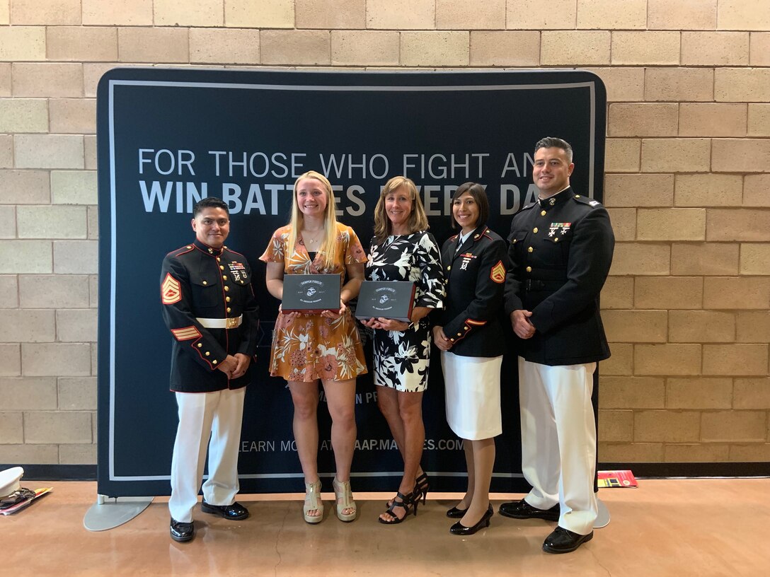 U.S. Marines with Recruiting Station San Diego present Mejan Janikowski and her mentor selection kits for the Semper-Fi All American Academy at Cathedral Catholic High School, May 1, 2019. The Battles Won Academy recognized students who are fighting and winning battles both on and off the playing field to make their communities and country stronger. (U.S. Marine Corps photo by Sgt. Bernadette Plouffe)