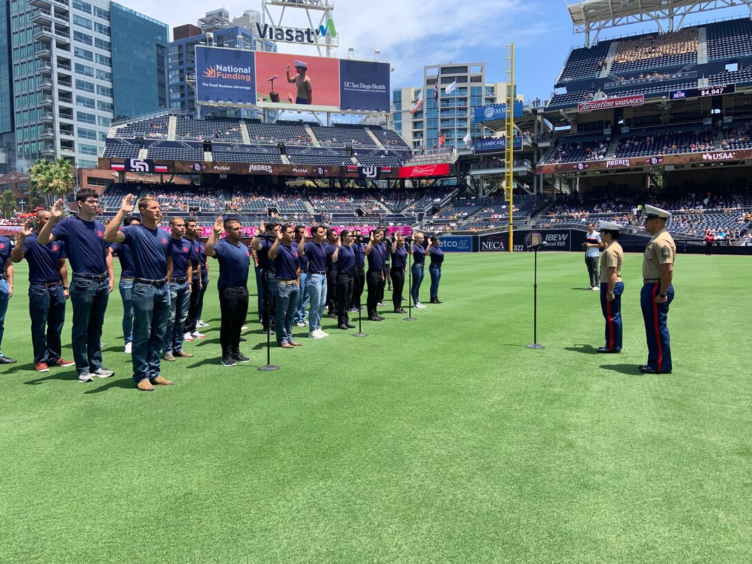 U.S. Marine Corps Capt. Katie Sliwoski, the Executive Officer of Recruiting Station San Diego, conducts the Oath of Enlistment with the RS San Diego poolees at Petco Park, July 28, 2019. The oath of enlistment is a military oath administered by a commissioned officer to any person enlisting or re-enlisting in any branch of service. (U.S. Marine Corps photo by Sgt. Bernadette Plouffe)
